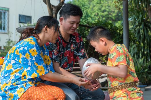 Ang Thong, Thailand - April 13, 2018 : Unidentified Asian young bathe with respect to parents by water have a jasmine and rose flower and aromatherapy in water in water bowl in Songkran Festival