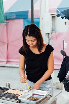 Bangkok, Thailand -  April 26, 2018 : Unidentified chef cooking a Mala is Grilled meat (Beef, Pork, Chickens or Mushroom) with chilli sauce and sichuan pepper for sale at street food market.
