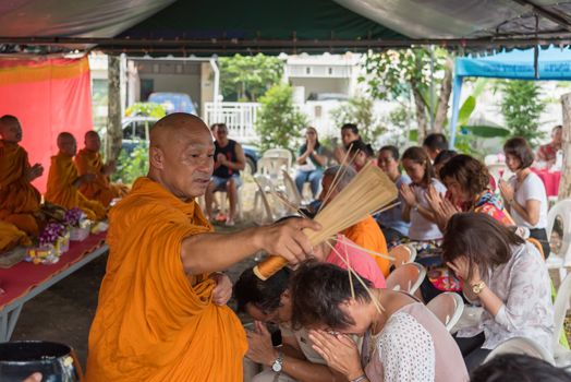 Bangkok, Thailand - April 29, 2018 : Unidentified thai monk praying and bless by holy water for religious ceremony in buddhist belief at Thai temple (Wat Thai)