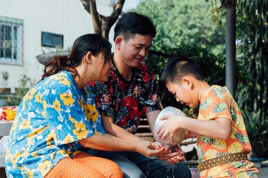 Ang Thong, Thailand - April 13, 2018 : Unidentified Asian young bathe with respect to parents by water have a jasmine and rose flower and aromatherapy in water in water bowl in Songkran Festival