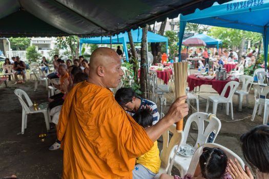 Bangkok, Thailand - April 29, 2018 : Unidentified thai monk praying and bless by holy water for religious ceremony in buddhist belief at Thai temple (Wat Thai)