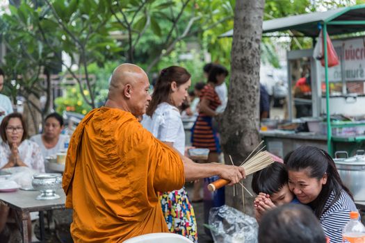 Bangkok, Thailand - April 29, 2018 : Unidentified thai monk praying and bless by holy water for religious ceremony in buddhist belief at Thai temple (Wat Thai)