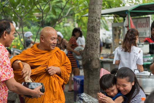 Bangkok, Thailand - April 29, 2018 : Unidentified thai monk praying and bless by holy water for religious ceremony in buddhist belief at Thai temple (Wat Thai)