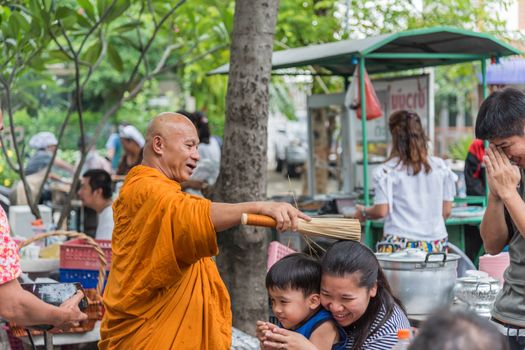Bangkok, Thailand - April 29, 2018 : Unidentified thai monk praying and bless by holy water for religious ceremony in buddhist belief at Thai temple (Wat Thai)