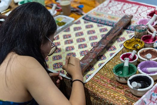 Bangkok, Thailand - June 16, 2018 : Unidentified Thai artist drawing a striped Thai art for making Thai silk design by Ayutthaya traditional contemporary fashion