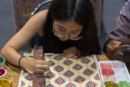 Bangkok, Thailand - June 16, 2018 : Unidentified Thai artist drawing a striped Thai art for making Thai silk design by Ayutthaya traditional contemporary fashion