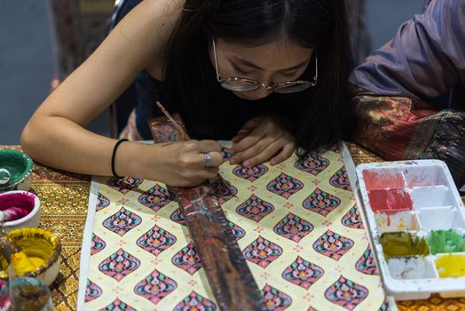 Bangkok, Thailand - June 16, 2018 : Unidentified Thai artist drawing a striped Thai art for making Thai silk design by Ayutthaya traditional contemporary fashion