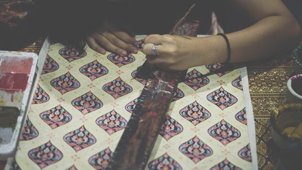 Bangkok, Thailand - June 16, 2018 : Unidentified Thai artist drawing a striped Thai art for making Thai silk design by Ayutthaya traditional contemporary fashion