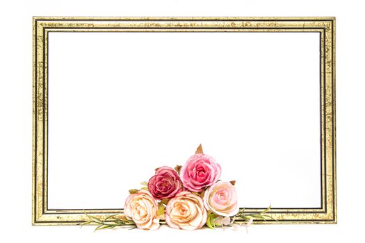 Gold colored wooden frame decorated with roses in pink, peach, amd yellow. Copy space for text. White background.