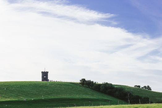 St Anthony Tower Milnthopre with open fields and blue sky