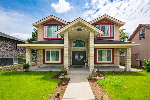 A perfect neighbourhood. Luxury family house with nicely landscaped front yard and concrete pathway to the entrance