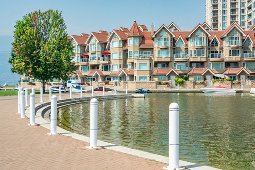 Luxury residential building with boat pier at the entrance. House at waterfromt in British Columbia