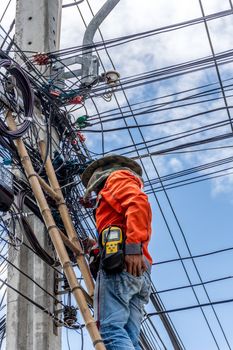 Bangkok, Thailand - June 26, 2016 : Unidentified worker working to install electric line by scaffolding on pickup truck at Bangkok Thailand.