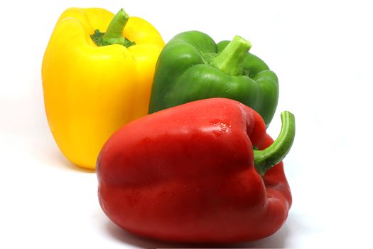 red, gree, and yellow bell pepper isolated on white background