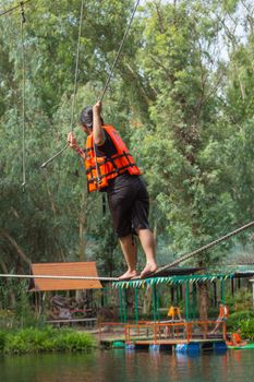 PathumThani , Thailand - June 25, 2016 : Unidentified asia people travel at adventure bases camp sky walker in Thailand