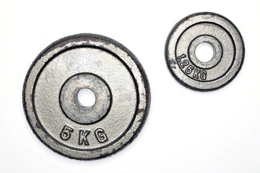 two old metal weight plates, isolated on white background