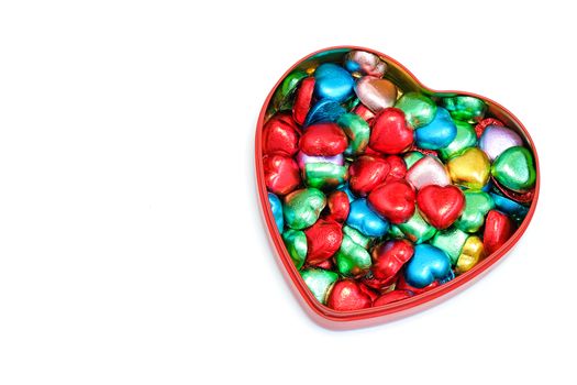 a box of heart-shaped chocolate candies, also in shape of a heart, isolated on white background, love, romance, Valentines' Day concept
