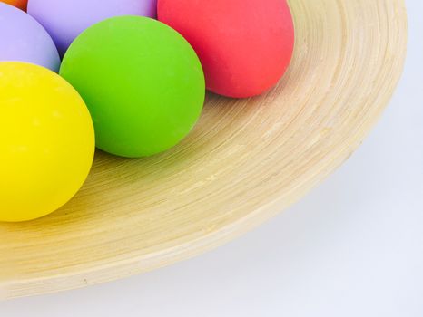 colorful homemade easter eggs in a bamboo trey, easter holiday concept