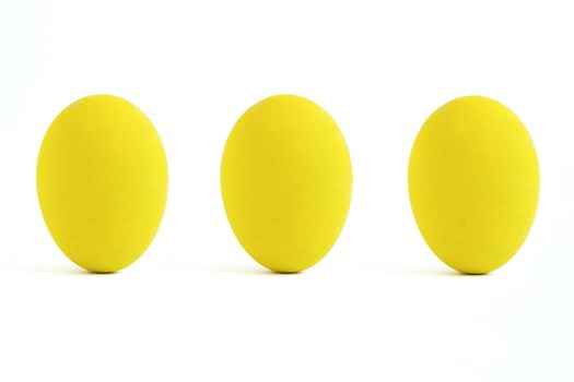 Three yellow paint eggs. isolated on white background