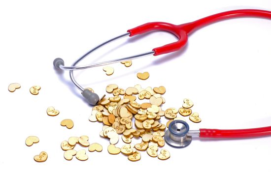 a red stethoscope and heart shaped wooden symbols engraved with letter 'love'