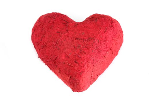 Handmade paper mache heart, closeup, isolated on white background. Love, romance, Valentine's Day concept.