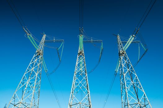 Electricity pylons in wide angle perspective, high voltage power lines, background photo, minimalism art