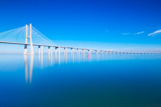Vasco da Gama Bridge mirrored on water, Lisbon, Portugal