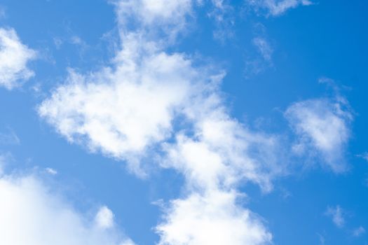 Blue sky with fluffy white clouds.