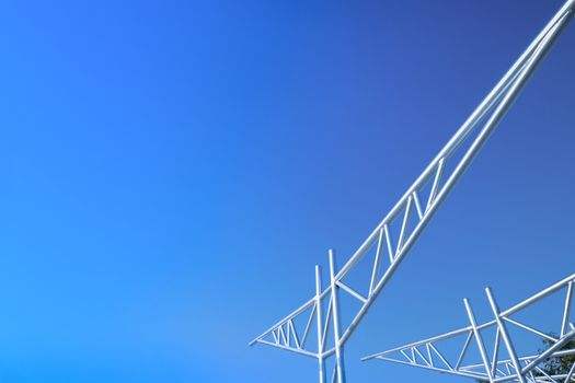 An image of unfinished metal trusses against bright blue sky.