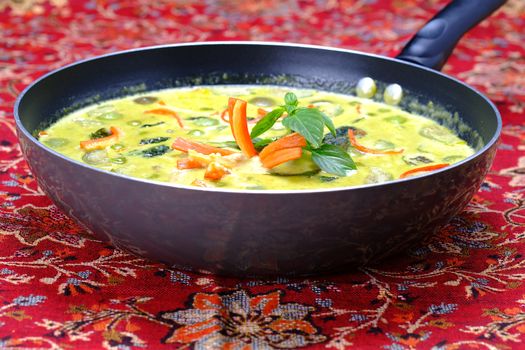 Ingredients for making famous Thai Green Curry with Chicken dish include, red and green chilli, holy basil leaves, kaffir lime leaves, turkey berry, and eggplant