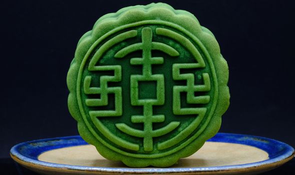 moon-cake, a traditional chinese dessert made of pastry with sweet cranberry and red bean paste fillings