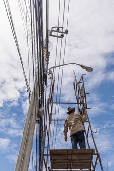 Bangkok, Thailand - June 26, 2016 : Unidentified worker working to install electric line by scaffolding on pickup truck at Bangkok Thailand.