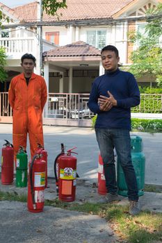 Bangkok, Thailand - January 31, 2016 : Many people preparedness for fire drill and training to use a fire safety tank in village at Bangkok Thailand.