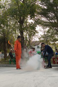 Bangkok, Thailand - January 31, 2016 : Many people preparedness for fire drill and training to use a fire safety tank in village at Bangkok Thailand.