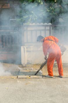 Bangkok, Thailand - January 31, 2016 : Unidentified people fogging DDT spray kill mosquito for control Malaria, Encephalitis, Dengue and Zika in village at Bangkok Thailand.