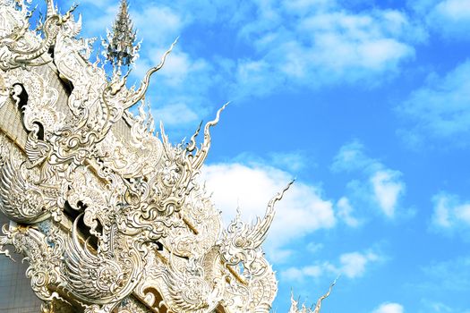 details of Northern Thai Buddist temple roof with imaginative mystical creatures, elaborate stucco style