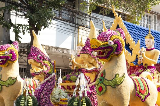 Details of mystical creatures decorated with fresh flowers on a float used in the February Flower Festival Parades in the City of Chiangmai, Thailand.