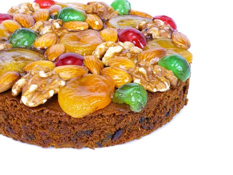 traditional fruitcake with fruits and nuts for the holidays, isolated on white background