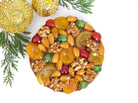 traditional fruitcake with fruits and nuts for the holidays, isolated on white background