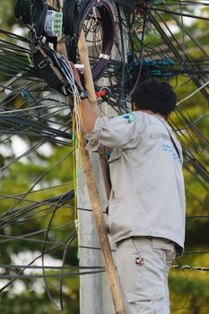 Bangkok, Thailand - November 16, 2015 : Unidentified worker working to install internet fiber system in village at Bangkok Thailand.