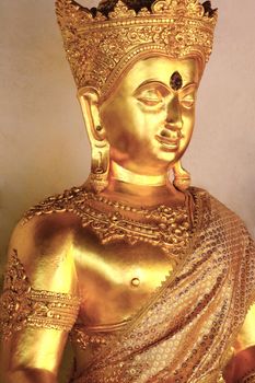 a golden buddha statue with a serene smile on his face