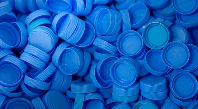The blue plastic lid that is left over from the bottles are collected to be recycled into other items for reuse.