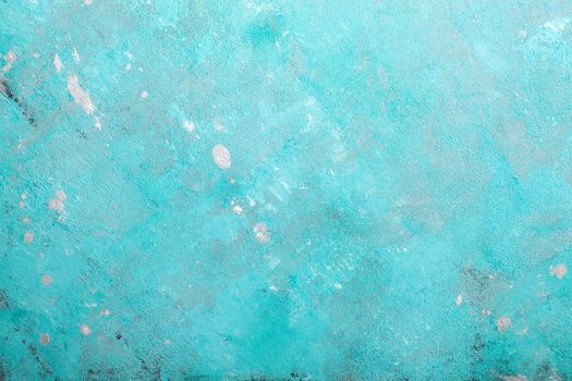 Concrete emerald green background with scuffs and black splashes. Textured wall texture in the grunge style.