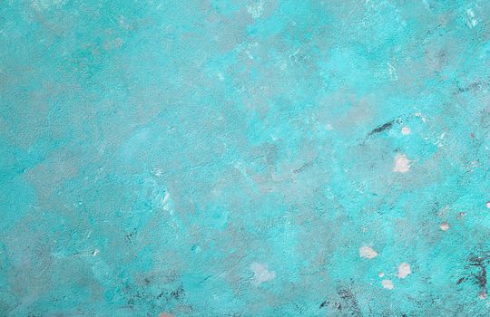 Concrete emerald green background with scuffs and black splashes. Textured wall texture in the grunge style.