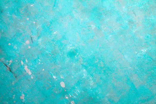 Concrete emerald green background with scuffs and black splashes. Textured wall texture in the grunge style.