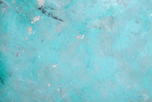 Concrete emerald green background with scuffs and black splashes. Textured wall texture in the grunge style.
