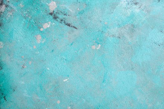 Concrete emerald green background with scuffs and black splashes. Textured wall texture in the grunge style.