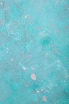 Concrete emerald green background with scuffs and black splashes. Textured wall texture in the grunge style.