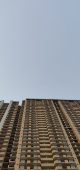 A high rise apartment building reaching for the sky in Delhi, India