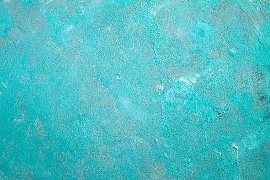 Concrete emerald green background with scuffs and black splashes. Textured wall texture in the grunge style.
